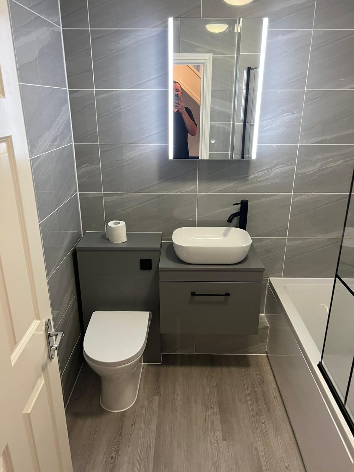 Compact bathroom with a sage vanity unit and countertop basin