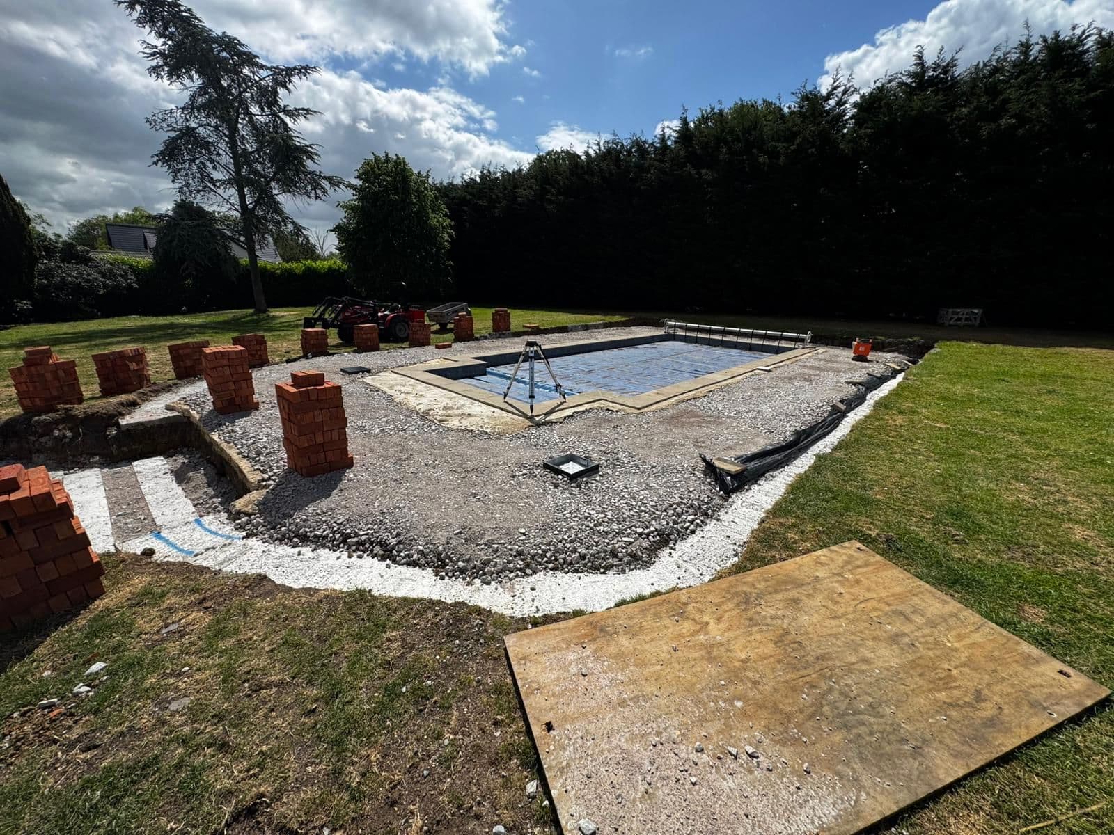 Swimming pool under construction with blockwork and groundwork